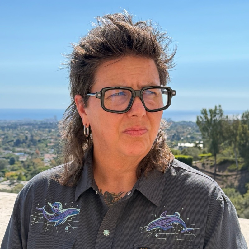 Christy Schaefer outdoors, with the city and ocean behind